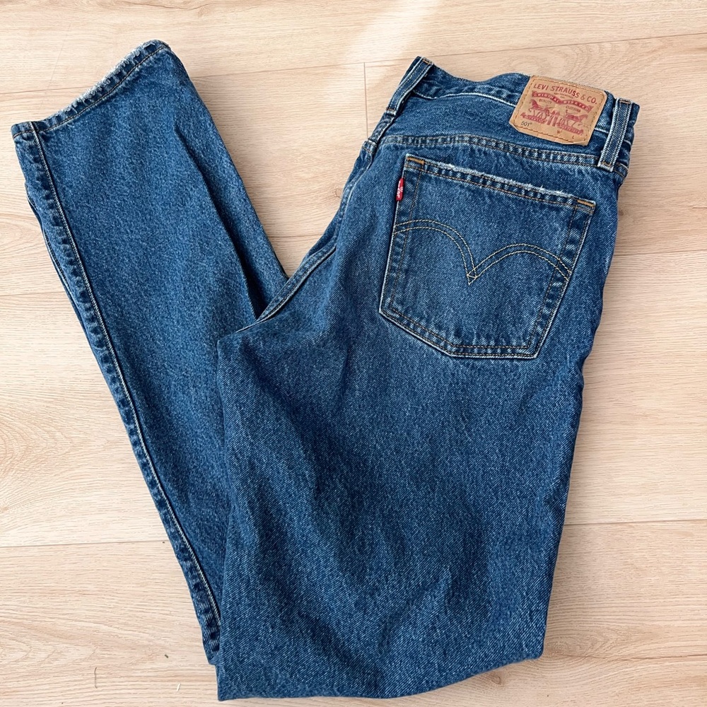 Women’s Levi's 501 blue ripped jeans.
